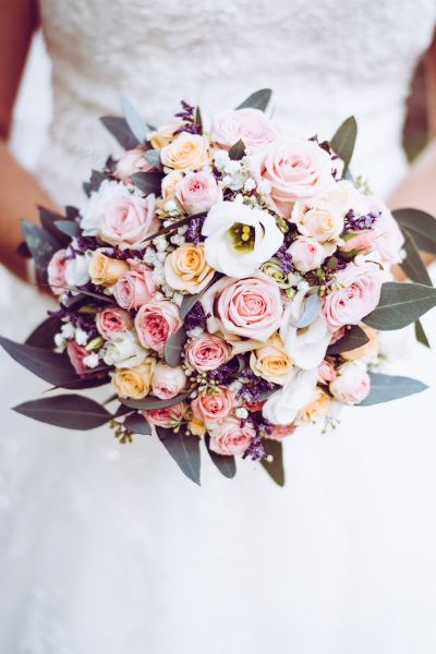 Bride in wedding dress holding flower bouquet